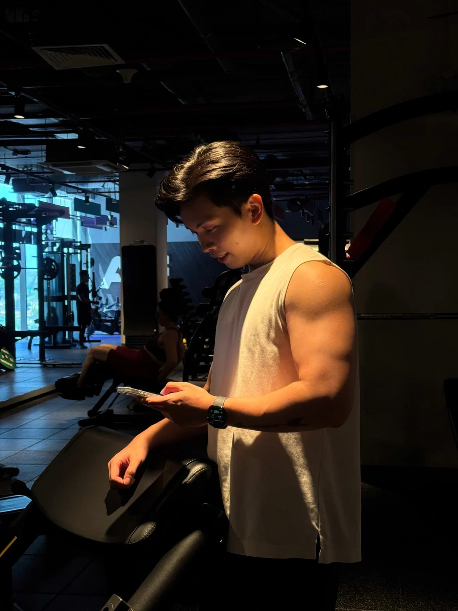 Khanh Duy checking his phone at the gym