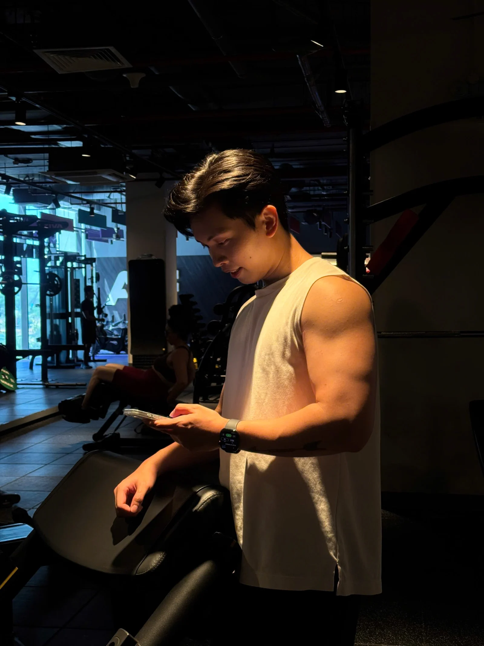 Khanh Duy checking his phone at the gym